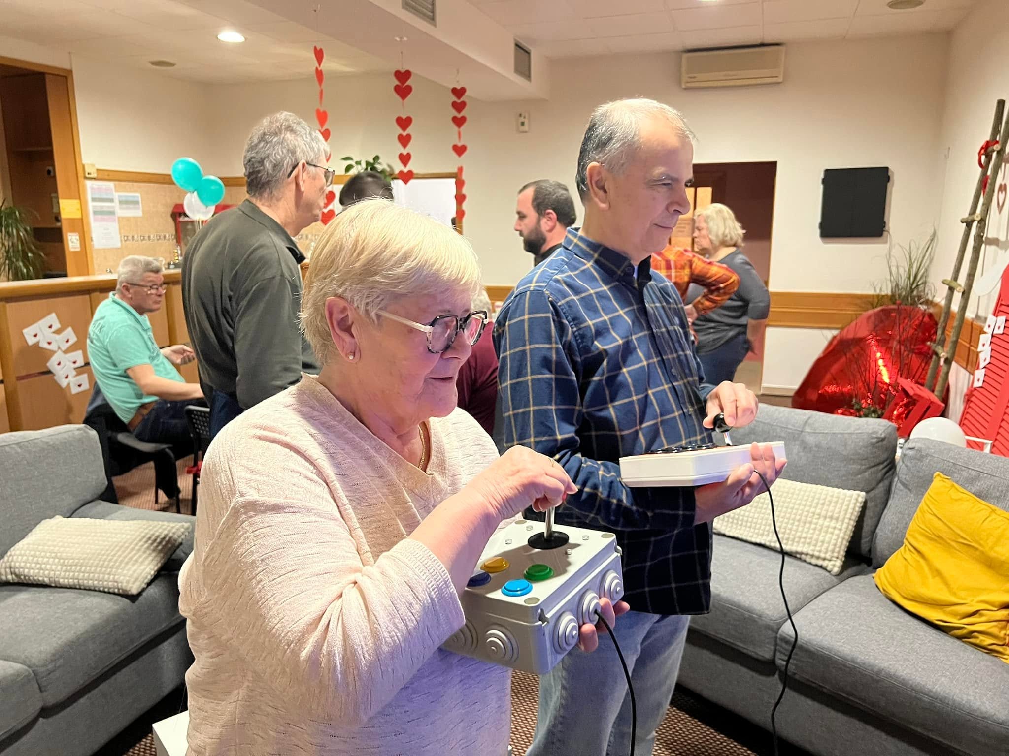 Two UGSO members holding their individual joystick controllers during a game.