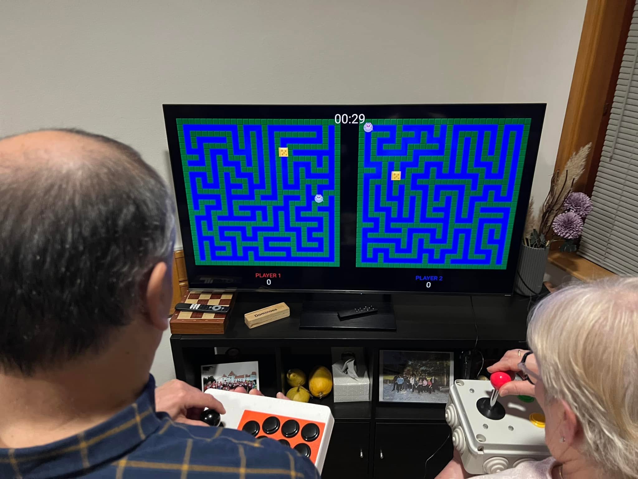 Two players facing the TV as a timed maze round begins.