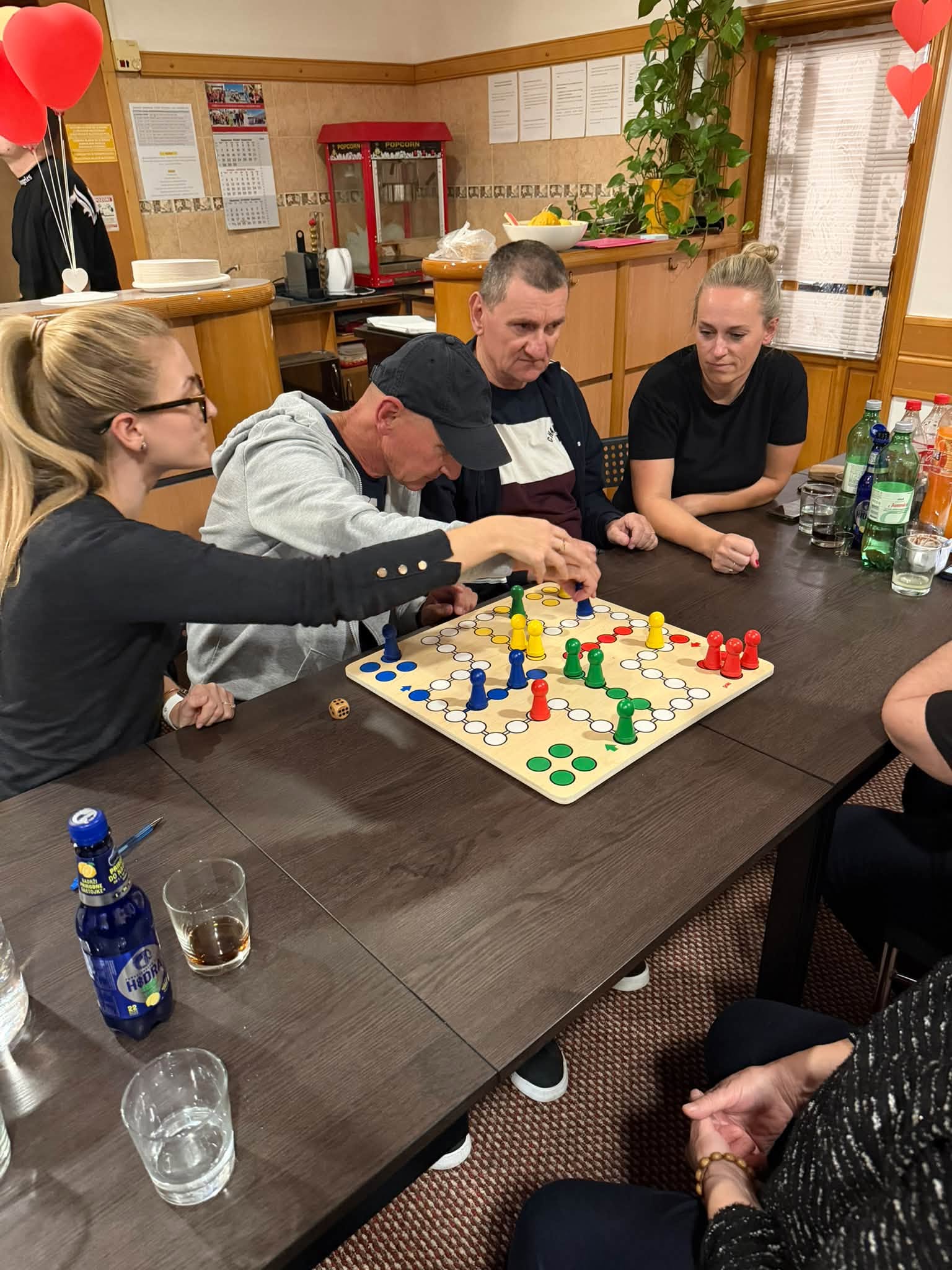 People playing a board game together at a table in UGSO's space.