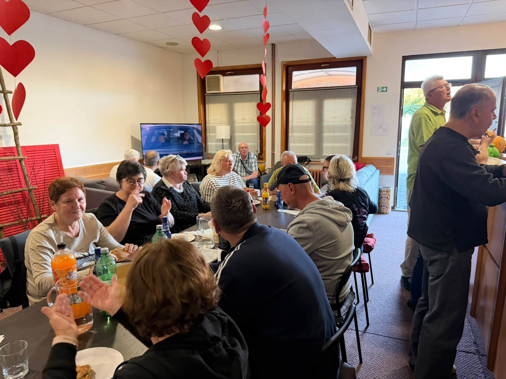 People talking around a table in UGSO's community room.