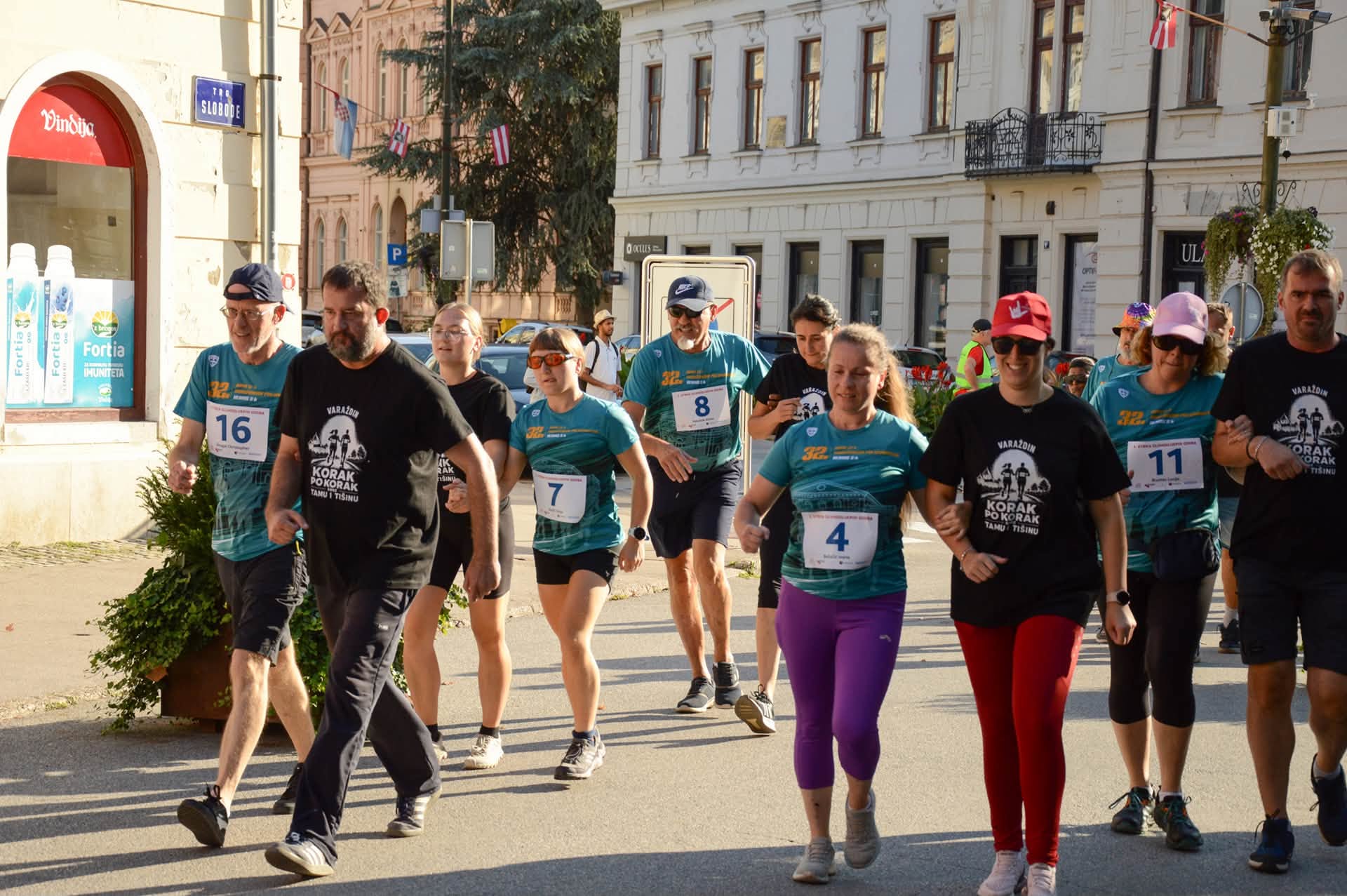 Participants and support people walking together on a street in central Varaždin.